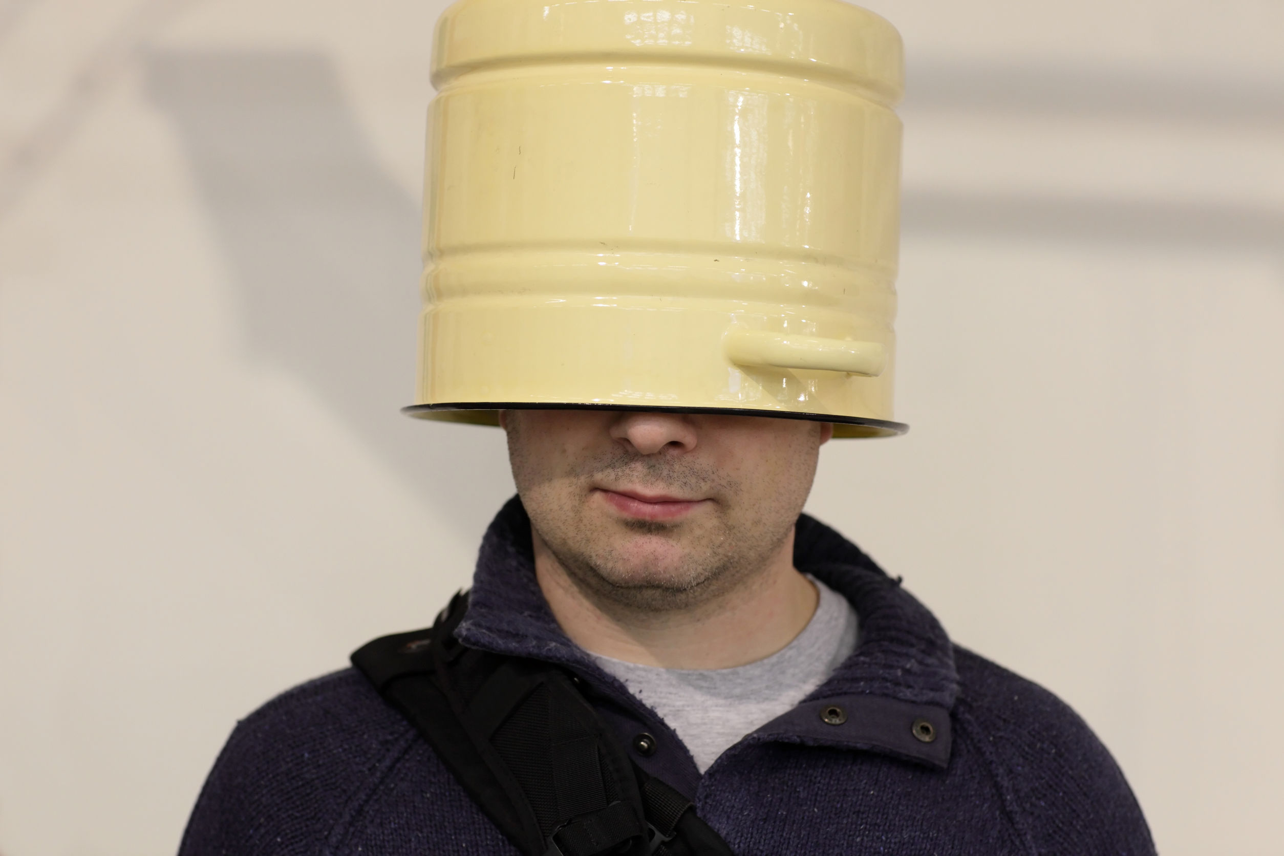 25449118 - the blinkered man with a bucket on his head